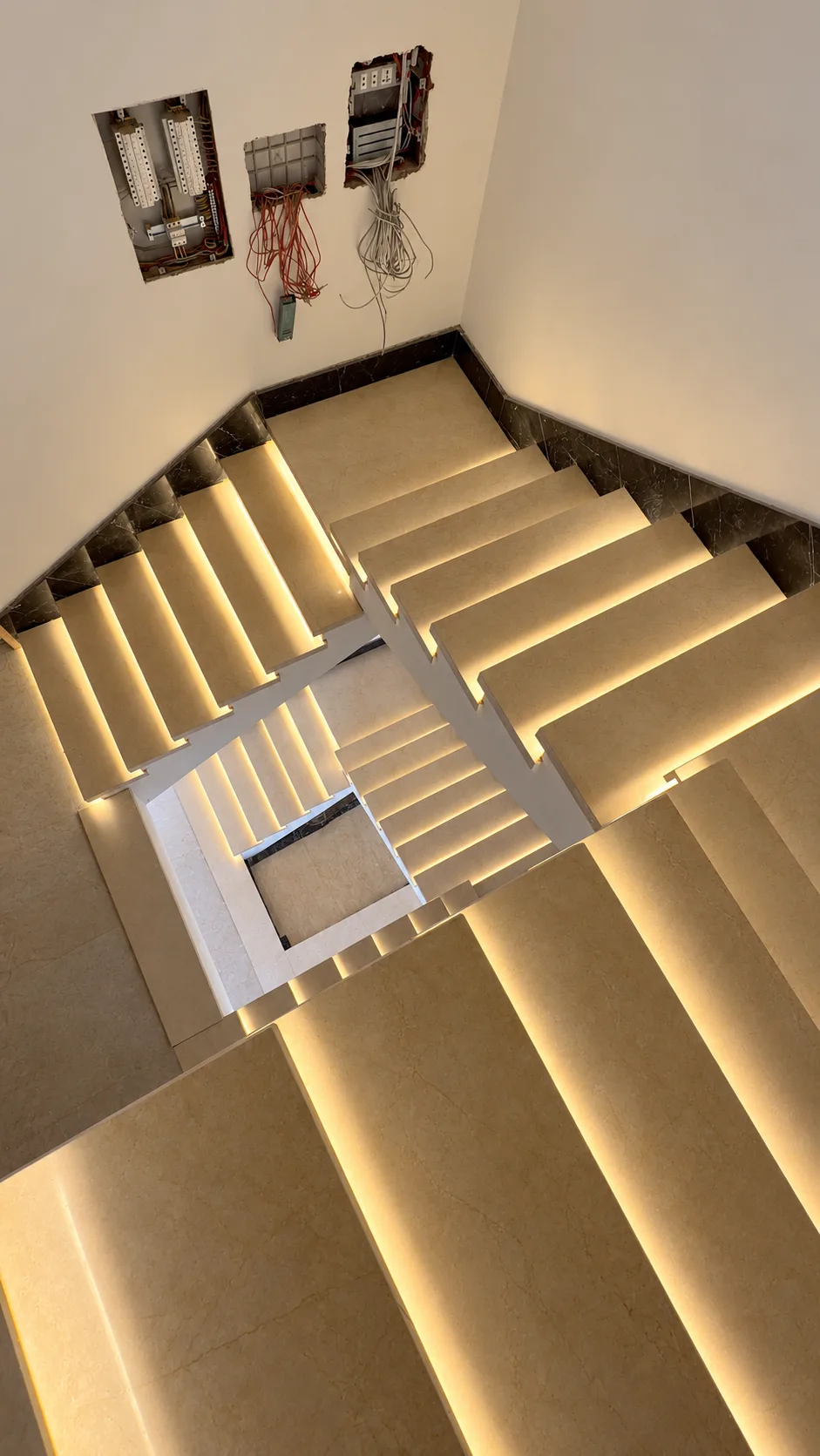 Looking up the stairwell: each step lit from below.