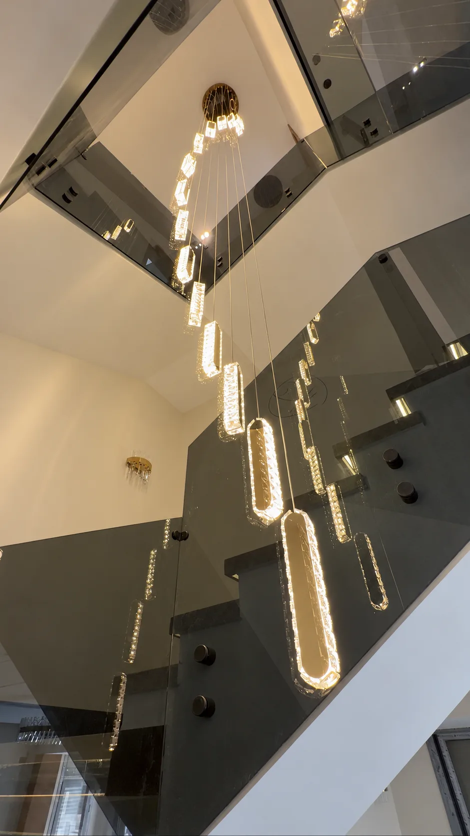Looking up through the chandelier to the upper floors of the stairwell.